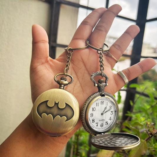 Vintage-style Batman metal pocket watch with keychain attachment featuring the iconic bat symbol