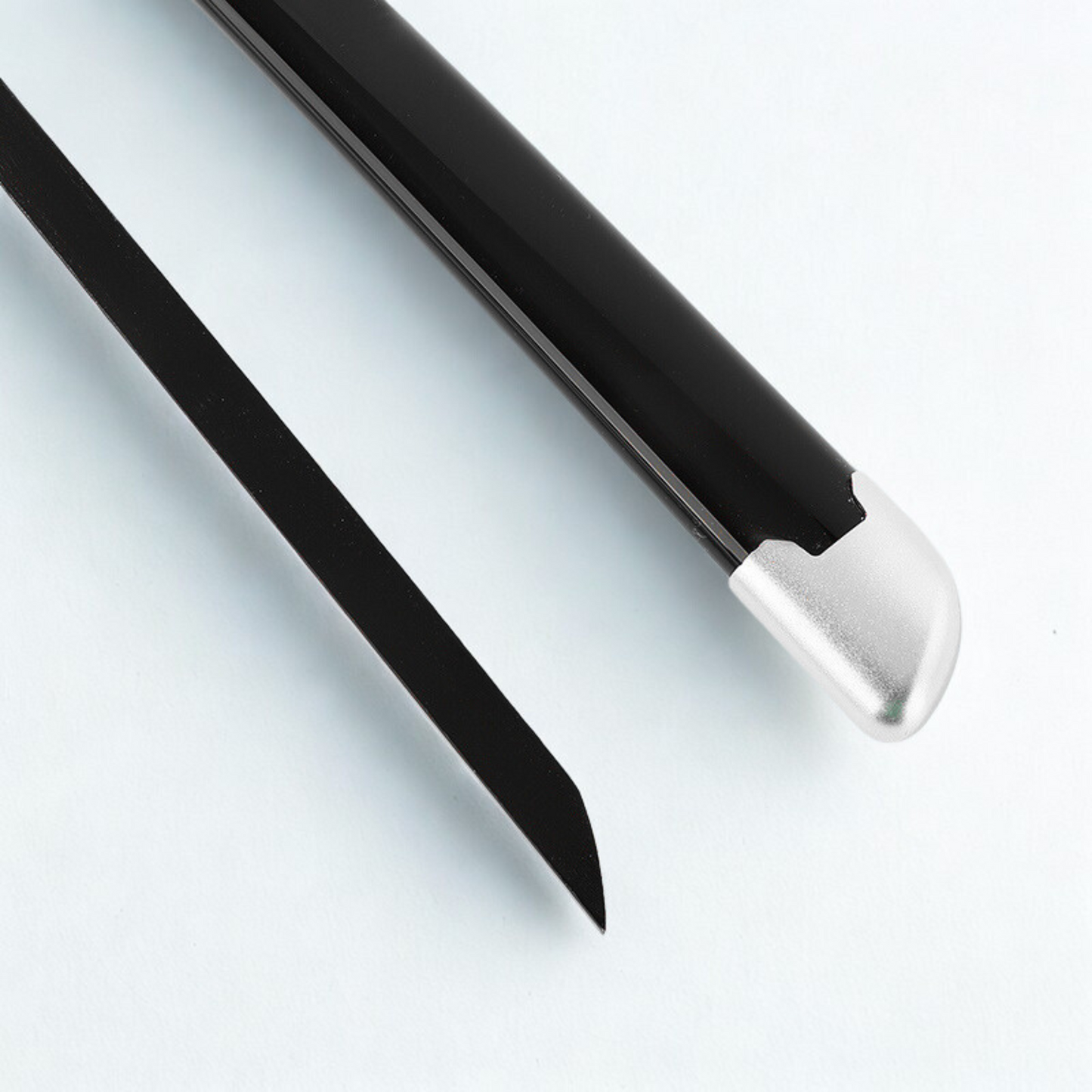 Close-up of Tanjiro’s serrated black blade with unique katana handle design