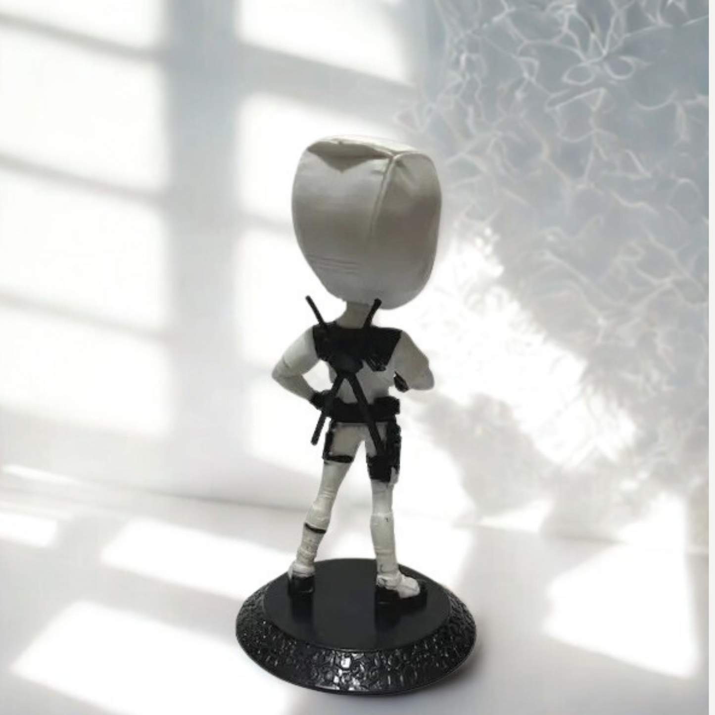 Close-up of Deadpool’s playful expression in white costume – detailed figurine