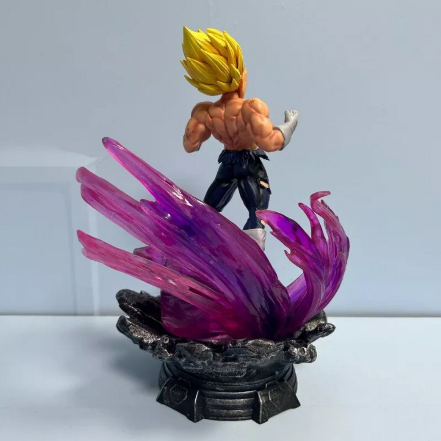 Dragon Ball Z action figure of Super Saiyan Ultra Instinct Vegeta with LED base, purple energy swirl, and interchangeable heads.