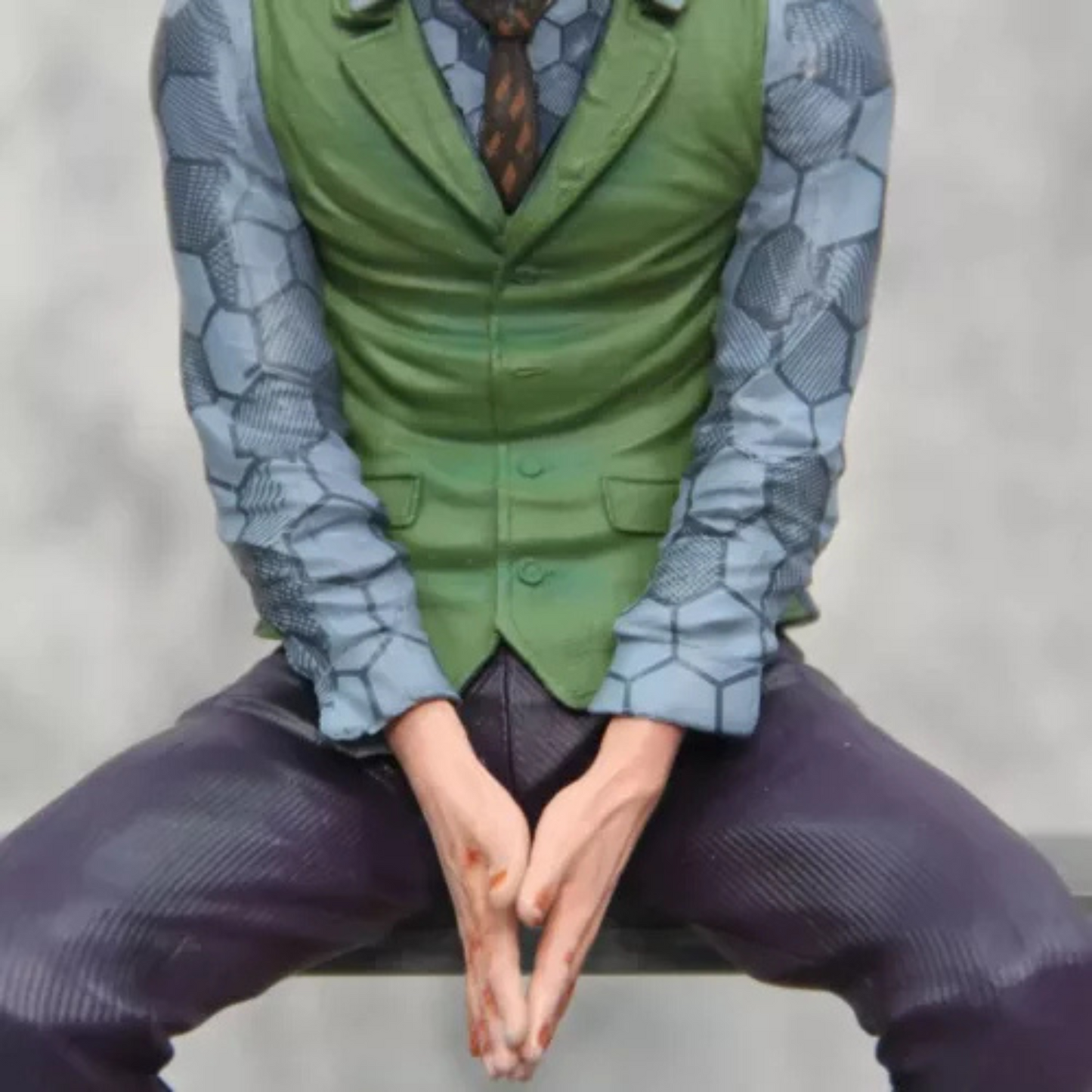 Close-up of Joker’s sinister grin and piercing gaze – detailed DC Comics figure