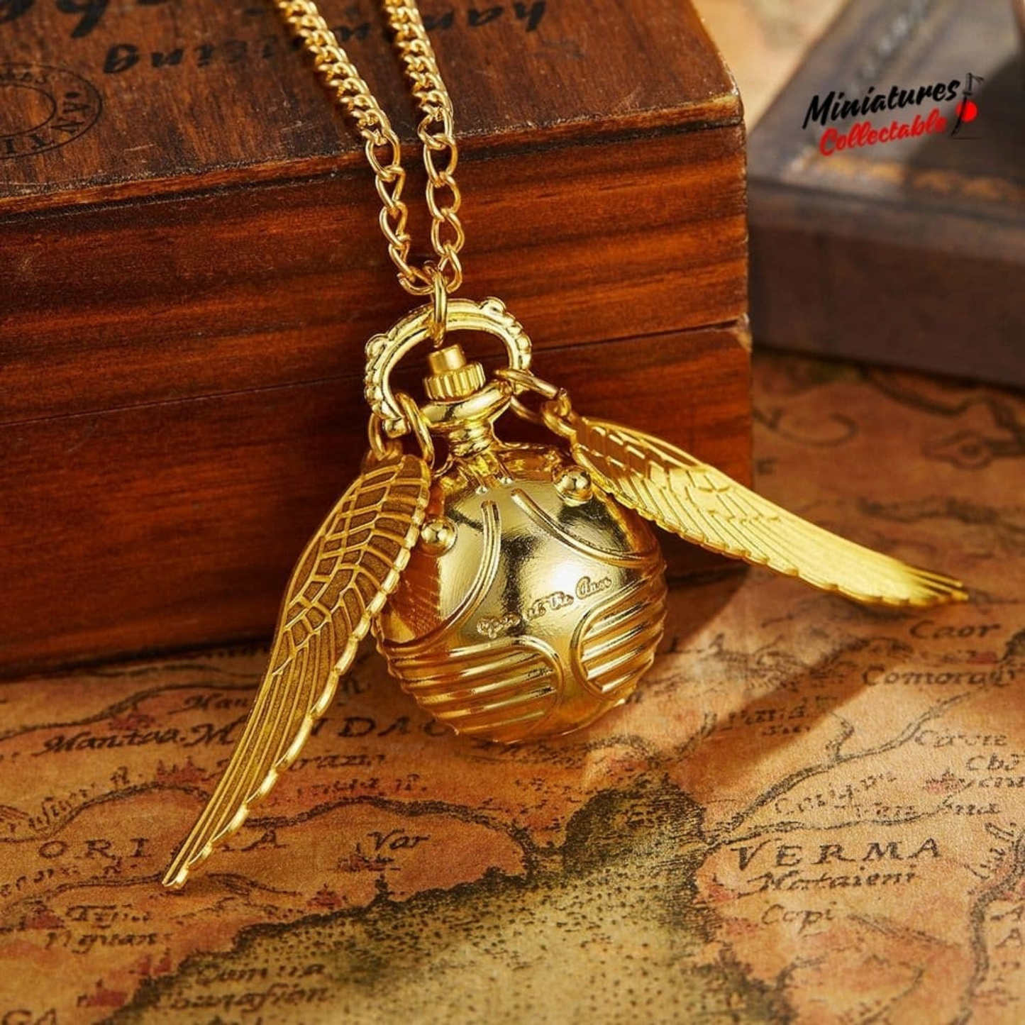 Golden Snitch pocket watch necklace with wings – Harry Potter themed collectible on golden mirror