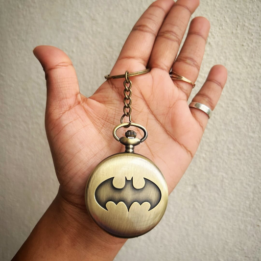 Vintage-style Batman metal pocket watch with keychain attachment featuring the iconic bat symbol