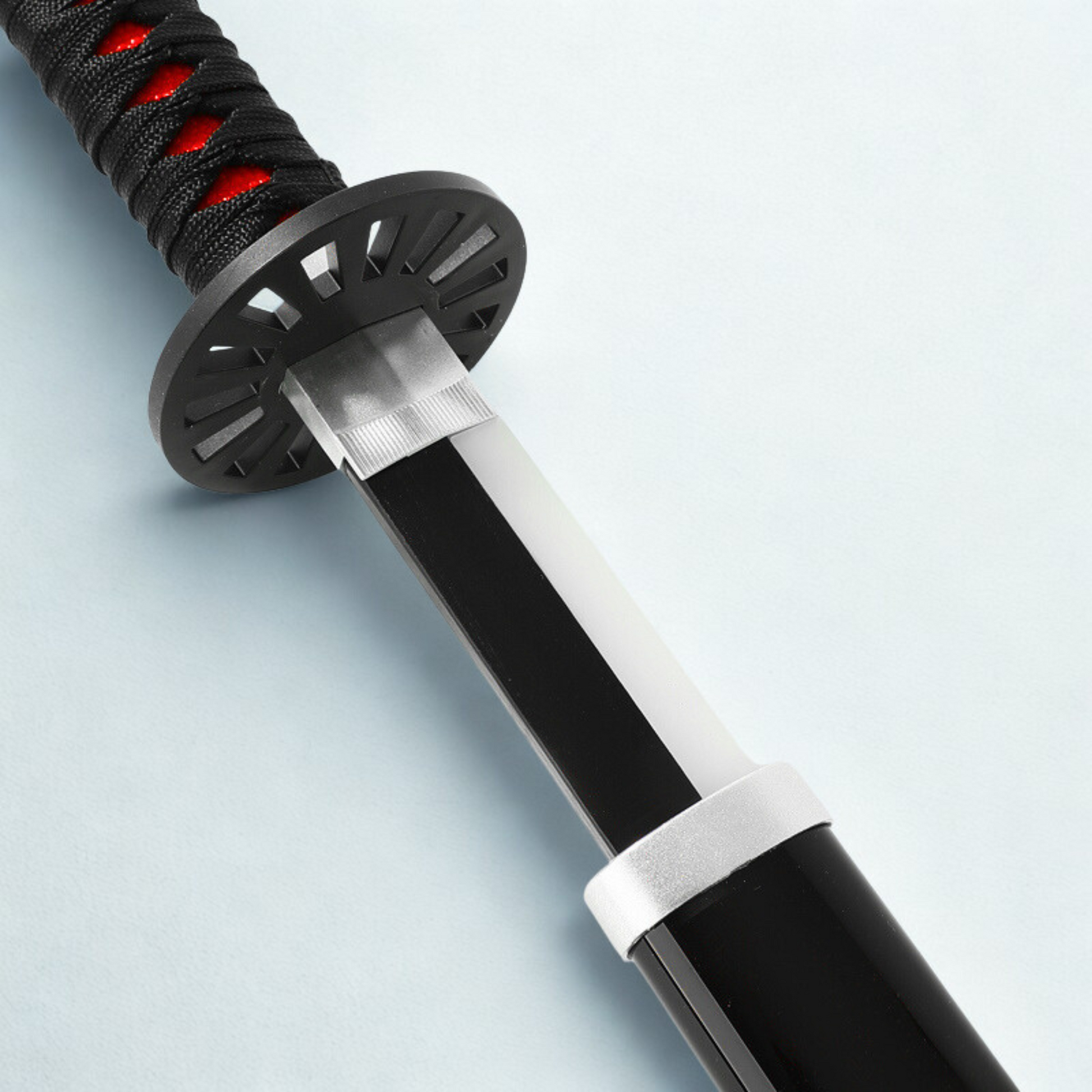 Close-up of Tanjiro’s serrated black blade with unique katana handle design