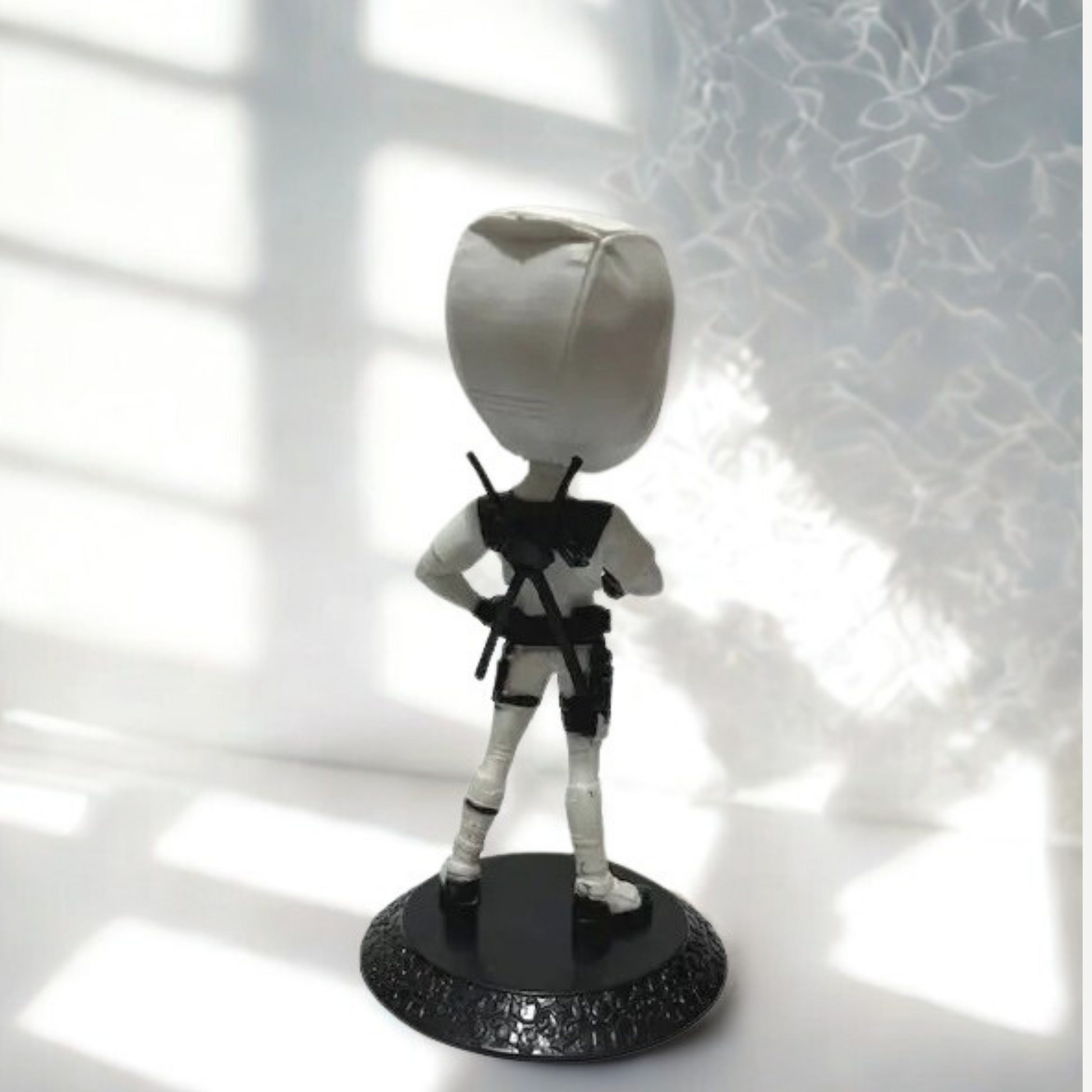 Close-up of Deadpool’s playful expression in white costume – detailed figurine