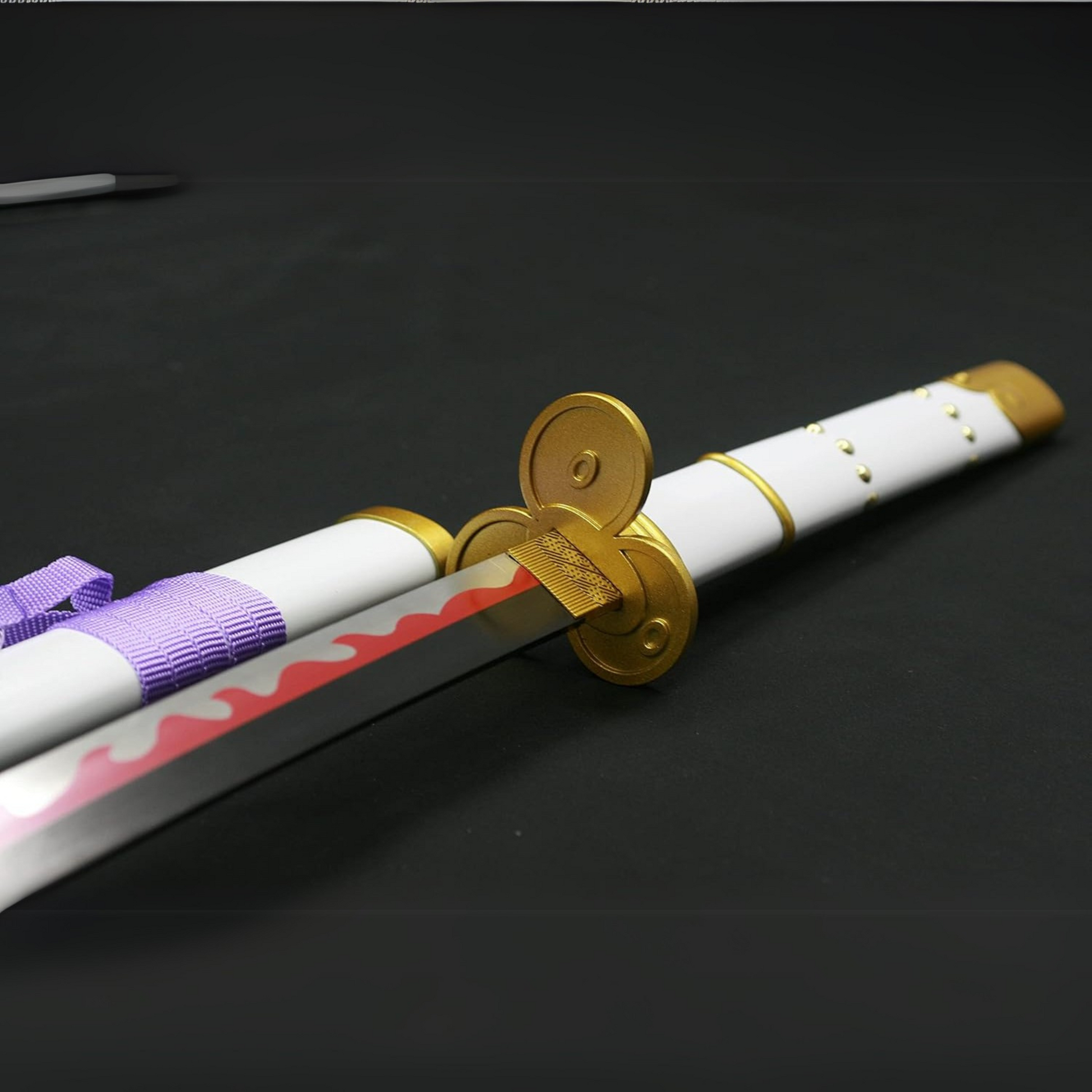 Zoro’s white Enma wooden katana displayed with white and gold hilt