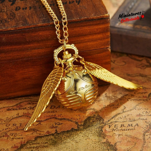 Golden Snitch pocket watch necklace with wings – Harry Potter themed collectible on golden mirror
